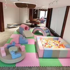 Our Pastel Soft Play Area offers a gentle and modern aesthetic for any party. This setup includes a soft-walled ball pit, foam climbers and slides, a cushioned rainbow arch, and a manual carousel, all laid out on safe, interlocking floor mats.