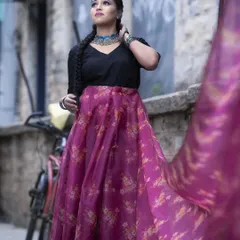 This indo-western look is perfect for a sangeet or mehendi. The makeup is modern and chic, with a defined eye and a neutral lip, paired with bohemian-style braids and silver jewellery.