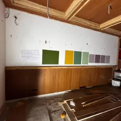 The color selection process is a story in itself. Here you can see the numerous paint samples we tested on a wall to find the perfect shades for a project, ensuring the final mood is exactly right.