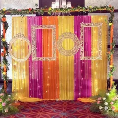 How do you make your mehendi ceremony pop? With a fun and colorful photo booth, of course. We created this backdrop using bright fabric drapes, ornate vintage frames, and delicate fairy lights, giving guests the perfect spot for memorable pictures.