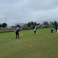 Training drills are designed to simulate match conditions and improve team coordination. Players engage in a fielding drill, honing their agility and teamwork under the watchful eye of our coaching staff.