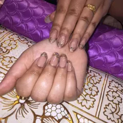 A beautiful and elegant set of permanent nail extensions. I used a sheer nude base and applied a delicate gold glitter fade at the tips for a sophisticated touch of sparkle.