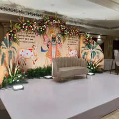A wider view of the Shrinathji-themed decor, showing the full stage setup. We take great care to ensure our designs for religious events are both beautiful and respectful of cultural traditions.