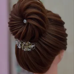 Another fantastic creation by a student. This intricate bun with delicate twists and accessories shows great skill and attention to detail.