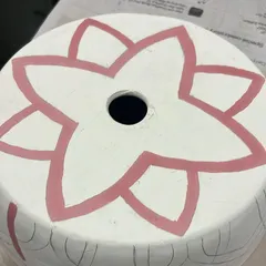 The first layer of color is applied to the lampshade design. This step starts to bring the pattern to life.