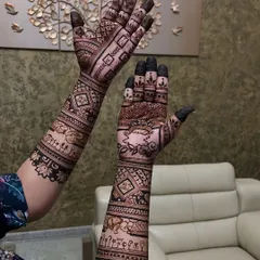 Another angle of the baby shower mehendi, showing the cute little elements like tiny feet and cradles woven into the design.