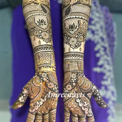 An elegant engagement design with peacock and lotus motifs, featuring delicate net patterns and a beautiful flow from hand to arm.