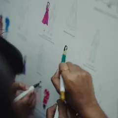 An interactive and personal touch. Guests had fun finding their illustrated selves on this custom guest board and coloring in their outfits, creating a collaborative and colorful memento of the day.