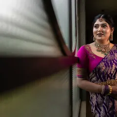 A wide, atmospheric shot of a bride-to-be in a long corridor. The dramatic lighting and leading lines create a cinematic and moody portrait.