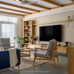 The 'Cover me in Sunshine' living room showcases our modern cottage style. We used graceful arches to shape entryways and a mix of curves and straight lines in the TV unit, while ceiling rafters add character against the muted beige walls.
