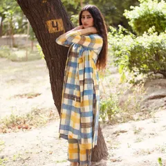 Another perspective of the plaid co-ord set, showing how the jacket moves with the model. Capturing different angles and poses provides a comprehensive view for the customer, helping them understand the garment's structure and versatility.