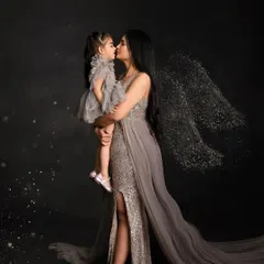 A mother's love gives you wings. This artistic portrait features a mother and daughter in an embrace, with sparkling angel wings added for a touch of magic and emotion.
