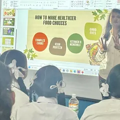 Educating the next generation on nutrition is a core part of my mission. Here, I'm explaining the fundamentals of healthy food choices to high school students, making wellness concepts accessible and relevant to their lives.