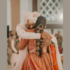 A heartfelt embrace after the Varmala ceremony. This emotional moment between the bride and groom is a testament to the love and relief of finally being united.