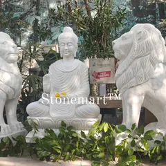 The combination of the serene Buddha and powerful lions creates a unique and balanced aesthetic. These statues are carved from solid blocks of white marble and are built to withstand the elements.