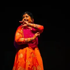 A close-up capturing the art of Abhinaya, or expressive storytelling, during a live performance. Every glance and hand gesture holds a meaning, connecting with the audience on an emotional level.