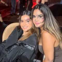 Two friends enjoying the party with their custom Halloween makeup. One features a stitched wound and the other a linear, tribal-inspired face paint design.