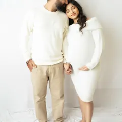 A tender moment between expecting parents, coordinated in soft white outfits. This minimalist setup keeps the focus purely on your emotion and connection.