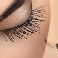 This macro image details our precision work. It shows a handmade lash fan just before it is applied to a single natural lash, which is the foundation of a beautiful volume set.