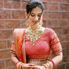 A bride in her stunning red Tarun Tahiliani lehenga, a portrait of grace amidst the natural beauty of Mahabaleshwar. The hills themselves seemed to celebrate her radiance.