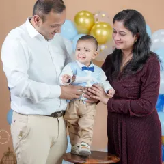 Helping their little one stand tall. This photo symbolizes the love and support that surrounds him as he grows.
