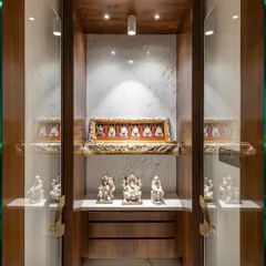 A closer look at the home temple in the Filigree House. Enclosed in glass and rich wood, this space is a beautifully lit sanctuary for idols and spiritual items, designed with reverence and care.