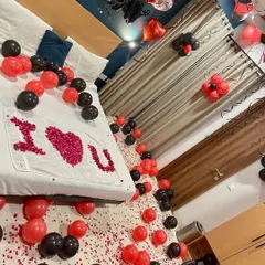 A wider view of our red and black themed room decoration, showing how balloons on the floor and ceiling can completely transform a space for a surprise celebration.