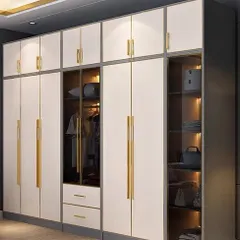 A modern floor-to-ceiling wardrobe in white with elegant gold handles. This design includes a glass-paneled section for displaying accessories, combining open and closed storage beautifully.