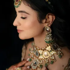 A stunning close-up of the bride, showcasing her intricate polki and emerald jewelry. My focus is on capturing these beautiful details that complete the bridal look.