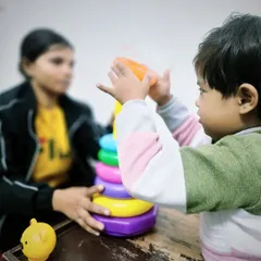 Stacking rings is a classic activity for a reason. During this speech therapy session, we use it to teach colors, sizes, counting, and turn taking, all while developing the child's fine motor skills.