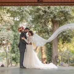 A breathtaking wedding portrait with the bride's veil catching the wind. This shot combines classic romance with a touch of drama, creating a truly memorable image from their special day.
