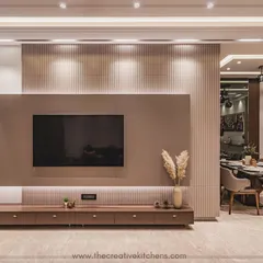 Detail is paramount in our designs. This image highlights the clean lines and flawless PU finish of the modular TV unit, set against a textured fluted panel wall. The warm, downward-facing spotlights enhance the unit's form and create a sophisticated focal point.