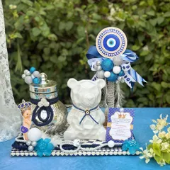 Shield your bundle of joy with style. This enchanting evil eye hamper combines protection and charm, featuring a modern white bear jar and traditional 'nazar' motifs.