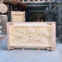 Transform a plain wall into a masterpiece. This intricate sandstone panel, hand-carved with a serene scene of lotuses and cranes, showcases the incredible skill of our Balinese artisans and brings natural artistry indoors.