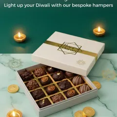 Light up your Diwali with my bespoke chocolate hampers. This box of 16 assorted handcrafted chocolates, featuring a mix of bonbons and rochers, comes in a beautiful gift box with a 'Happy Diwali' tag, ready for gifting.