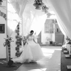 A beautiful shot of the bride walking down a path, her dress flowing, capturing a moment of quiet grace before the ceremony.