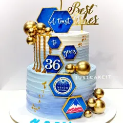 A two-tier cake to celebrate an employee's retirement after 36 years of service. The design is professional, incorporating the company's logo and colors.