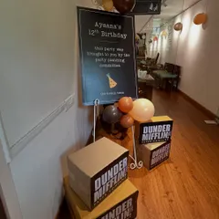 The welcome signage for 'The Office' themed birthday party. We used the show's classic font and humor, along with stacks of Dunder Mifflin paper boxes, to immediately immerse guests in the theme from the moment they arrived.