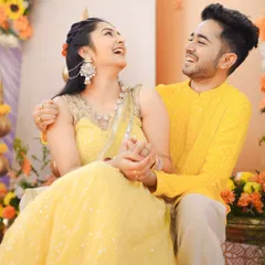A candid moment of shared laughter between the couple during their Haldi. Dressed in coordinated yellow outfits, their connection shines through, making for a perfect, happy portrait.