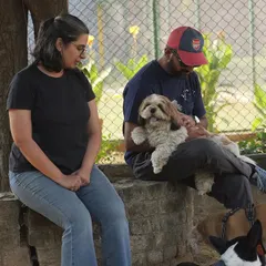 Pet parents relaxing and socializing while their dogs play nearby. Our dog parties are as much for the people as they are for the pets, creating a community of like-minded animal lovers.