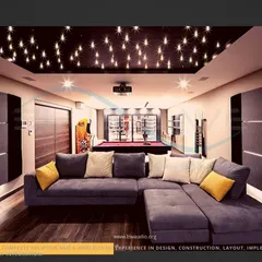A spacious entertainment room designed for both movie watching and socializing. It features a large L-shaped sofa, a starlight ceiling over the viewing area, and a pool table and arcade machine in the back.