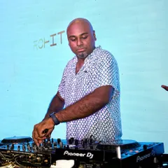 Focused behind my trusted Pioneer DJ console. For me, it's all about precision mixing and reading the crowd to play the right track at the right time, ensuring the dance floor never stops.