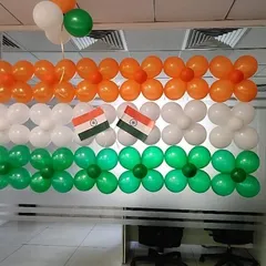 An Independence Day decoration featuring the Indian flag made from balloons on a glass wall.