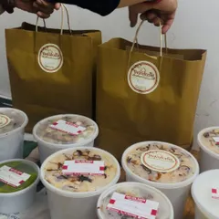 Our branded paper bags and sealed containers, ready for delivery. We provide the best home-cooked food in South Delhi, including party catering and combo meals.