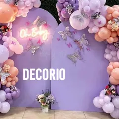 A variation of the butterfly theme, this baby shower setup uses a rich purple palette. The "Oh Baby" neon sign adds a modern glow, while glittery butterfly cutouts on the backdrop create a sparkling effect.