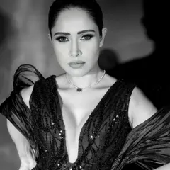 A stunning close-up monochrome portrait of Nushrratt Bharuccha, where the lighting sculpts her features and highlights the delicate necklace.