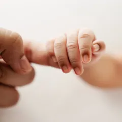 The instinctual grasp of a newborn's hand around their parent's finger. It's one of the most powerful and simple connections.