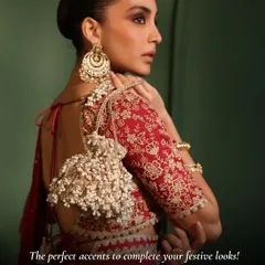 It’s all about the finishing touches. This handcrafted potli bag, with its cascading pearl tassels and delicate embroidery, is the perfect statement piece to elevate your festive saree or lehenga for a wedding reception or Diwali party.