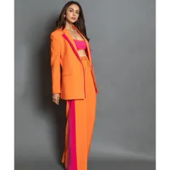 A full-body shot of the orange and pink pantsuit, a perfect rental for making a statement at any event.