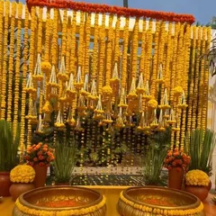 We love bringing the vibrant energy of a Haldi ceremony to life. This setup features a dense wall of fresh marigolds (genda) and traditional brass urlis, creating a picture perfect, sun-kissed setting for your pre-wedding festivities.